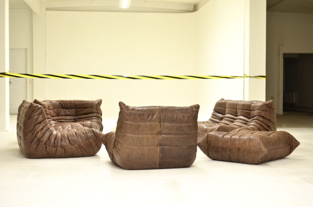 Brown leather chairs behind caution tape, symbolizing property protection under the Due Process Clause.